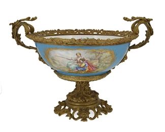 3089
A Sèvres-Style Porcelain Compote
Fourth-Quarter 19th Century
The circular compote centering a figural reserve and with polychrome floral motifs on a celeste blue ground with gilt-bronze mounts and pedestal base
12.25" H x 17.5" W x 13.75" D
Estimate: $750 - $1,000
