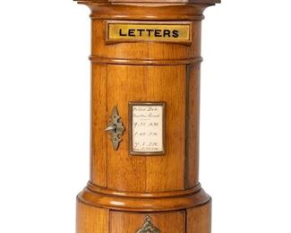 3110
An Edwardian English Postal Box
First-Quarter 20th Century
The oak pillar-form box with brass mounts
14" H x 7.5" Dia.
Estimate: $400 - $600