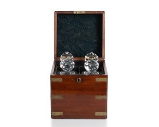 3113
A Cut Crystal Tantalus Set
Late 19th/Early 20th Century
With four cut lead glass decanters in a fitted brass-clad mahogany case
10" H x 8.75" W x 8.25" D
Estimate: $400 - $600