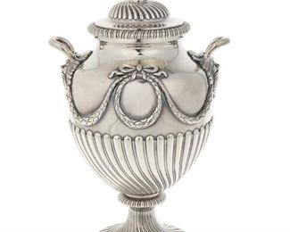 3116
An Edwardian English Sterling Silver Urn
1913
Marked with English hallmarks for London; maker's mark for Daniel and John Wellby
The Neoclassical-style covered urn with all-over spiraled gadrooning, ribbon-topped wreaths, and festoons flanked by loop handles with foliate masks
10.5" H x 6.25" W x 4.75" D
37.485 oz. troy approximately
Estimate: $1,000 - $1,500