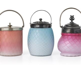 3127
Three Victorian Art Glass Biscuit Barrels
Late 19th/Early 20th Century
Blue jar inscribed to underside: 65 Kat; Peach jar impressed to lid: WF / 12; Blue jar with etched mark to underside: Patent
Possibly Mount Washington or Pairpoint, each pearl satin glass jar with quilted pattern and fitted with a silver-plated lid and handle, comprising an ovoid blue jar (8.75" H x 4.5" Dia.), a cylindrical peach jar (8.75" H x 5.5" Dia.), and a cushion-shaped pink jar (8.75" H x 4.75" Dia.), 3 pieces
Estimate: $500 - $700