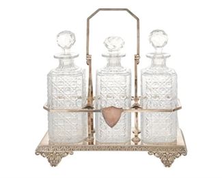 3150
An English Silver-Plated Tantalus Set
First-Quarter 20th Century
Marked for Albert J. Beardshaw & Co.
The silver-plated, handled case centering a shield and decorated with a festoon and star border raised on rocaille feet, fitted with three cut glass decanters with faceted stoppers
14.5" H x 13.5" W x 6" D
Estimate: $500 - $700