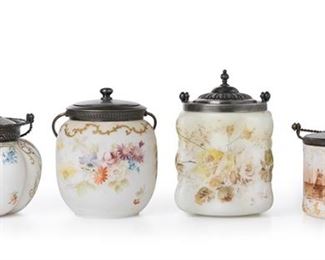 3174
A Group Of Pairpoint Mount Washington Art Glass Biscuit Barrels
Late 19th/Early 20th Century; New Bedford, MA
Four works:

A Pairpoint milkglass jar
Lid marked for Pairpoint: ["P" diamond monogram] / 3932; Glass numbered: 393 / 502
The cylindrical, molded milkglass jar with flat sides and raised scrolling borders fitted with a silver-plated lid and handle, decorated with a sepia-style harbor scene
8" H x 7" Dia.

A Mount Washington Crown Milano jar
With impressed "MW" mark to lid, numbered 4404 p; Crown Milano mark to underside of glass, numbered: 1050
The white matte glass jar polychrome painted flowers and gold enamel scrolls fitted with a silver-plated lid and handle
9.75" H x 5.75" Dia.

A Pairpoint Mount Washington Wave Crest-style jar
With impressed "MW" mark to lid, numbered 4415; Pairpoint mark to underside of glass, numbered 3914 / 26
The melon-form, white glass jar with polychrome painted flowers, gold enamel scrolls, and light pink gradient fitted with a silver-plated l
