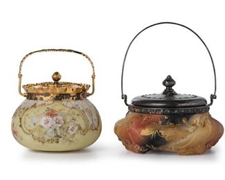 3173
Two Mount Washington Art Glass Biscuit Barrels
Late 19th/Early 20th Century; New Bedford, MA
Each with impressed "MW" mark to lid; one with Crown Milano mark to underside
Comprising a cushion-shaped Crown Milano white matte glass jar fitted with a gilt lid, handle, and ruffled rim decorated with polychrome painted floral designs and gold enamel on a light yellow ground (8.25" H x 6.5" Dia.) and a blown white glass jar fitted with a silver-plated lid and handle decorated with gilt enamel flowers on a red, black, and gold ground (10" H x 8" Dia.), 2 pieces
Estimate: $300 - $500