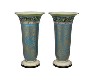 3213
A Pair Of Royal Doulton Trumpet Vases
Circa 1920s
Each with Royal Doulton underglaze mark and numbered in the glaze: 1399; one inscribed in black ink: BB-610
Each porcelain trumpet vase white iridescent cream glaze to the foot and interior, the exterior with gilt floral design on a teal ground and foliate border, 2 pieces
Each: 11.75" H x 6.5" Dia.
Estimate: $600 - $800