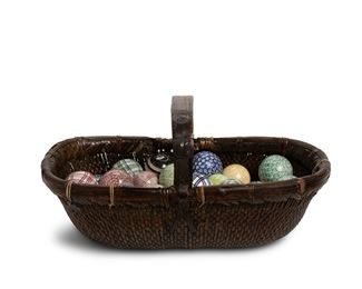 3220
A Collection Of Scottish Carpet Balls
20th Century
Each glazed ceramic ball in various colors and patterns, together with a wicker basket, 43 pieces
Larger: 3.25" Dia.; basket: 13" H x 27" W x 13.5" D
Estimate: $600 - $800