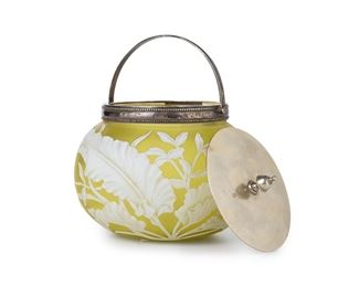 3243
An English Victorian Cameo Glass Biscuit Barrel
Fourth-Quarter 19th Century
Likely by Thomas Webb, the acid etched jar cut from opaque white to frosted chartreuse with leaf motif, fitted with a silver-plated lid and handle
7" H x 6" Dia.
Estimate: $500 - $700