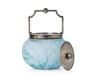 3245
An English Victorian Cameo Glass Biscuit Barrel
Fourth-Quarter 19th Century
Lid with impressed marked for Walker & Hall, numbered 2748; rim with impressed marked for John Grinsell & Sons, numbered: 106
Likely by Thomas Webb, the acid etched jar cut from opaque white to frosted blue with leaf motif, fitted with a silver-plated lid and handle
8.25" H x 6" Dia.
Estimate: $500 - $700