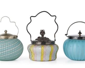 3246
Three Victorian Art Glass Biscuit Barrels
Late 19th/Early 20th Century
Three works:

A pearl satin quilted jar
Engraved number to lid: 1984
The white satin glass jar with pink and yellow ribbons and lattice motif fitted with a silver-plated lid and handle
9" H x 6" Dia.

A pearl satin swirled jar
With partially illegible maker's mark to glass underside; Metal rim with illegible maker's mark and "Made in England"
The translucent satin glass jar with blue and white swirls and ribbed body fitted with a silver-plated lid and handle
9" H x 6" Dia.

A pearl satin striped jar
Silver plate marked for James Deakin & Sons, numbered: F8639
Possibly by Webb, the light blue cased satin glass with vertical stripes fitted with a silver-plated lid and handle
8" H x 6.5" Dia.

3 pieces
Estimate: $600 - $800