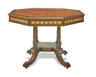 3287
A Victorian Renaissance Revival Octagonal Table
Third-Quarter 19th Century
The octagonal table with burlwood bookmatch parquetry top, ebonized and satinwood banded border, and gilt trim over a mounted apron with applied floral porcelain plaques enclosed in scrolled gilt-bronze framework supported by four fluted legs with incised gilt highlights joined by an X-stretcher raised overall on four swept legs with castors
29.875" H x 41.25" Dia.
Estimate: $1,000 - $2,000