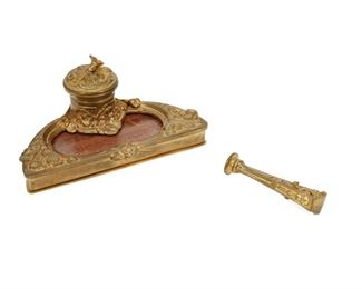 3289
An Albert Marionnet Art Nouveau Bronze Inkwell
Fourth-Quarter 19th Century
Signed in the casting: A. Marionnet; Impressed underside: A Marionnet / Bronzes / Paris / France / Depose
The gilt-bronze inkwell with nasturtiums centering a single lidded well over inset wood panel, together with a stamp
3.25" H x 7.125" W x 3.75" D
Estimate: $400 - $600