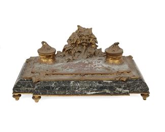 3291
An Albert Marionnet Art Nouveau Bronze Inkwell
Fourth-Quarter 19th Century
Signed in the casting: A. Marionnet
The bronze inkwell centering a foliate mask flanked by two wells raised on a green marble base
6.25" H x 14.75" W x 8.5" D
Estimate: $400 - $600