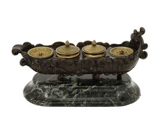 3292
A French Bronze And Marble Inkwell
Fourth-Quarter 19th Century
The bronze inkwell with all-over acanthus motifs centering four wells and four pen slots raised on a green marble base
7" H x 13" W x 5.5" D
Estimate: $400 - $600