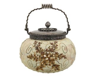 3311
A Mount Washington Crown Milano Art Glass Biscuit Barrel
Circa 1890s; New Bedford, MA
With Mount Washington paper label to underside; lid with impressed "MW" mark, numbered: 4419 / c
The white-cased matte glass jar with gold enamel starfish set with glass jewels against a hobnail surface with pastel pink, blue, and green designs, fitted with a silver-plated lid and handle with repousse seaweed motifs
9.25" H x 7" Dia.
Estimate: $600 - $800