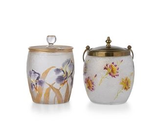 3312
Two Art Glass Biscuit Barrels
Late 19th/Early 20th Century
Two works:

A Mont Joye jar
With gold stamped Mont Joye mark
the lidded jar with enamel painted purple irises and gilt leaves against a frosted clear ground
6.75" H x 5" Dia.

An acid etched jar
With enamel painted flowers and gilt details against a textured clear ground fitted with a brass lid and handle
10" H x 5" Dia.

2 pieces
Estimate: $400 - $600