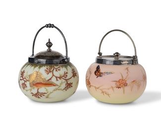 3313
Two Victorian Art Glass Biscuit Barrels
Late 19th/Early 20th Century
Two works:

A Webb Burmese jar
With Webb "Queen's Burmese Ware" mark to underside
The rounded satin glass jar fading from light pink to light yellow decorated with gold enamel flowering branches and painted butterflies, fitted with a silver-plated lid and handle
7.5" H x 6.25" Dia.

A seashell jar
The rounded, white satin glass jar painted with seashells, kelp, and gold enamel details, fitted with a silver-plated lid and handle
8" H x 6" Dia.

2 pieces
Estimate: $300 - $500