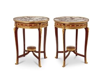 3333
A Pair Of French Louis XV-Style Lamp Tables
Late 19th/Early 20th Century
Each with inset figured marble top, gilt-bronze edge over a circular conforming base with Louis XV-style legs and gilt-bronze mounts throughout, with conforming stretcher and central fern stand with pierced gallery rail
Each: 30.25" H x 26" Dia.
Estimate: $4,000 - $6,000