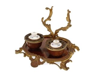 3341
A French Louis XV-Style Inkwell
Late 19th/Early 20th Century
Incised in the casting: MB
With veneered wood and gilt-bronze mounts featuring two wells with porcelain lids
5.25" H x 8.125" W x 8" D
Estimate: $350 - $500