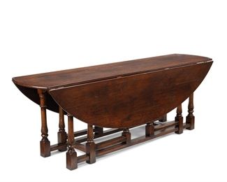 3356
A Large Oak Drop-Leaf Gate Leg Table
Fourth-Quarter 20th Century
With a round drop-leaf top raised on turned wood double gate legs with molded apron
30" H x 90" W x 22" D; open: 61" D
Estimate: $800 - $1,200