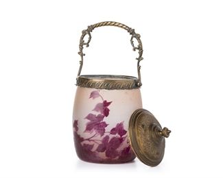 3359
A Legras "Rubis" Series Cameo Glass Biscuit Barrel
First-Quarter 20th Century
With acid etched signature: Legras
The cylindrical jar with acid etched cut-back magenta ivy pattern over a frosted clear ground fitted with a brass lid and handle
10" H x 4.5" Dia.
Estimate: $300 - $500