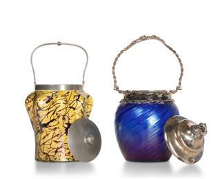 3363
Two Loetz-Style Art Glass Biscuit Barrels
Late 19th/Early 20th Century
Comprising an iridescent yellow jar with purple threads and lobed body fitted with a metal lid and handle (10.5" H x 5.5" Dia.) and an iridescent blue jar with striped decoration and pinched body fitted with a silver-plated lid and handle (11" H x 5.5" Dia.), 2 pieces
Estimate: $300 - $500