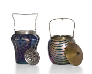 3362
Two Loetz-Style Art Glass Biscuit Barrels
Late 19th/Early 20th Century
Each iridescent blue glass with iridescent yellow decoration, comprising a tapered jar with pulled design fitted with a silver-plated lid and handle (10.25" H x 5.5" Dia.) and a rounded jar with festoons fitted with a brass lid and handle (9.5" H x 5.5" Dia.), 2 pieces
Estimate: $400 - $600