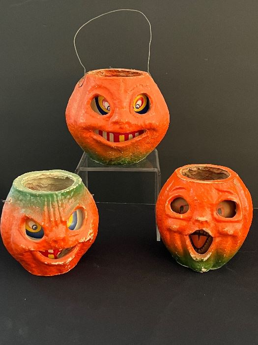 Three Vintage Paper Mache Pumpkins with varying degrees of wear including some paint loss and the largest one has a rip on the side which can be seen in the photo gallery. 