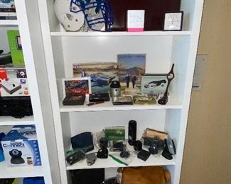 Vintage cameras and equipment. Air Force memorabilia, model plane kit, golf decor, briefcase, football helmet 