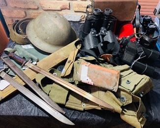 Many WW1 and WW 2 military items plus a Civil War 10 lb cannon ball. Notice we also have three pair of binoculars and a spotting scope. The binoculars include a pair of Leupolds. 