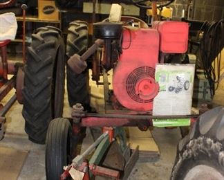 Economy Tractor with Greenish Booklet at Back Corner by Roto Machine