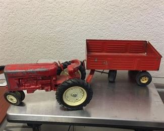 $25 - VINTAGE ERTL RED METAL FARM TRACTOR & TRAILER - PATINA IS CONSISTENT WITH AGE
