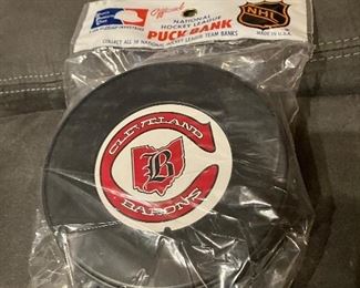 Unopened 1970’s Cleveland Barons puck bank. 