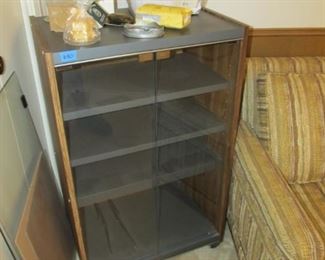 A nice rolling cabinet with glass doors