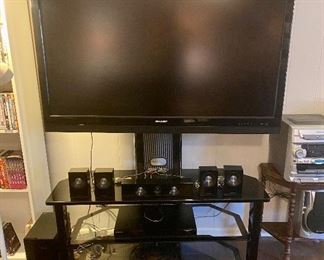 52” Sharp flat screen with glass stand. 
Samsung 6 speaker surround sound and receiver. 