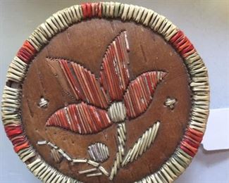 A hand-crafted bark basket adorned with quills.