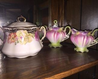 A porcelain biscuit jar and unusual cream and sugar set.