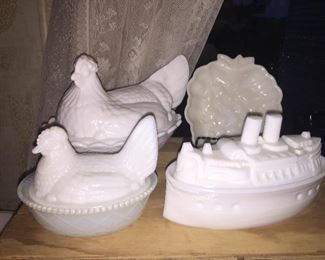 A Fenton hen on nest, back left, a smaller unbranded hen, an unusual ship covered dish and a grape trinket dish.