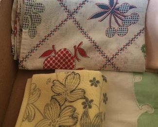 Whether topping a table or stacked in a display cabinet, vintage tablecloths add color.