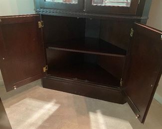 Lighted Corner Cabinet with 2 adjustable glass shelves. No name on cabinet. Measures 39" wide across the front. 2' deep. 6' 9" tall. Moves in 1 piece. Asking $250. 