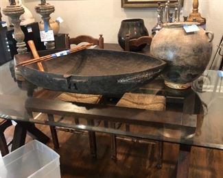 Modern glass top table, New Guinea feast bowl, Mexican pottery