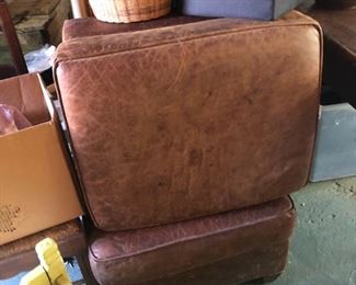 pair of leather ottomons