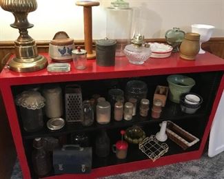 Great shelf with primitives of all kinds - shakers pottery, salt keeper, storage jars, childs plates, wire, lunch bucket, grater etc.