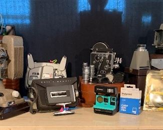 Variety of projectors (two 16mm film and one slide), one Polaroid Instamatic with package of film, two 35 mm cameras, one Bolex 16mm movie camera with four additional lenses and Weston exposure meter. 