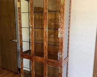 Campaign style lighted display cabinet - 4 glass doors open, brass hardware - measures 82H x 40W x 15D with 6 interior shelves