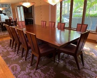 Exquisite custom made extension dining table and 10 upholstered chairs - table is 120"L x 54"W and extends an additional 15" to each end - the chairs are 37.5"H x 15.75"W and seats are 21"D