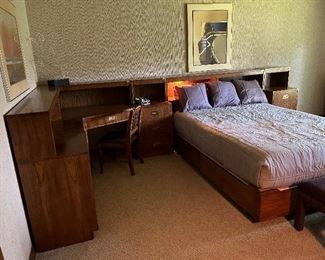 Dixie Campaigner Queen bedroom suite includes bed surround and lighted bookshelf headboard, 2 nightstands, corner desk with chair, 6 drawer credenza - all pieces can be separated to suit your space - art work not available