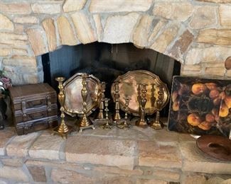 Brass candlesticks and trays on the hearth 