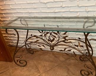 Mid Century Modern glass top sofa table.  The base is wrought metal leaves.  