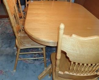 oak table and press back chairs