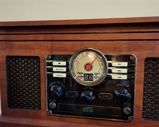 Fabulous reproduction of a vintage record player.  Maybe used a half dozen times.  Has cassette player and comes with stand and record holder.